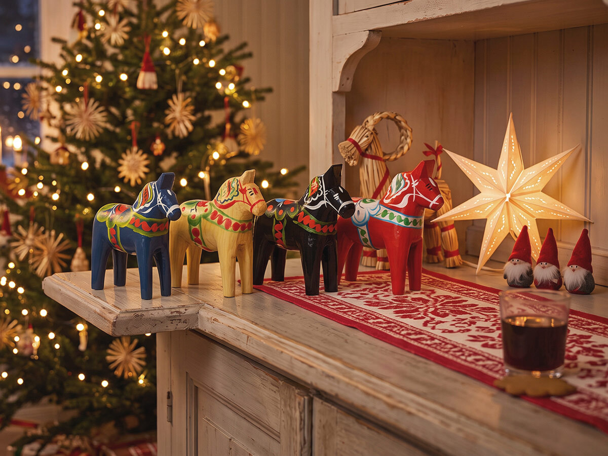 Painted red Dala horses on a shelf in a Swedish home