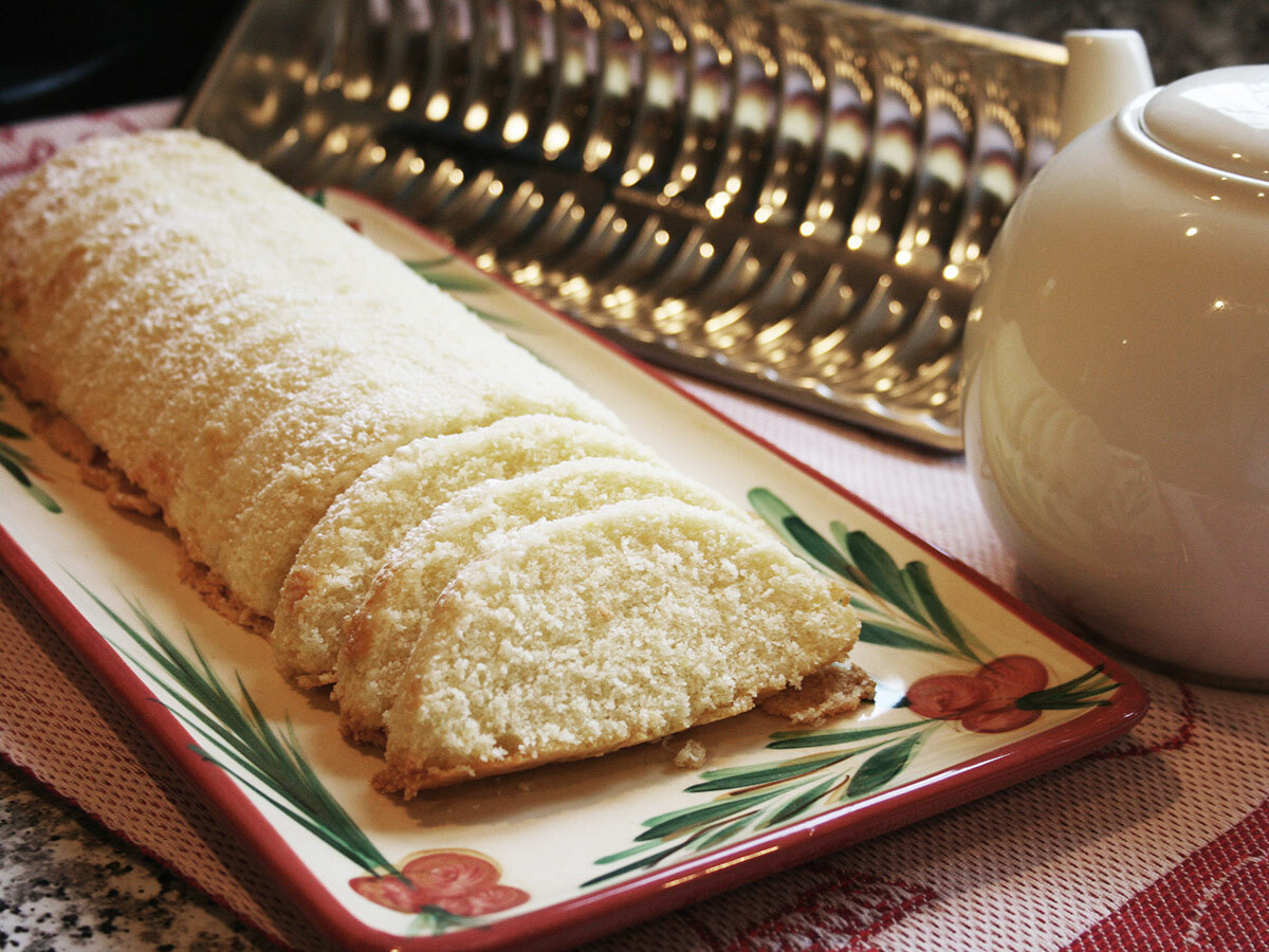 Grammy Greta&rsquo;s Swedish almond cake, baked in a fluted pan and dusted with confectioners&rsquo; sugar